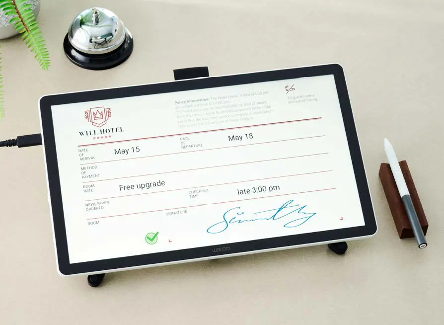 Wacom DTH142E pen and touch display used for signing a hotel form